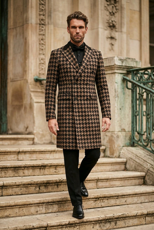 A man wearing a brown and black houndstooth patterned overcoat, black trousers, and a black bow tie walks down stone steps in front of a classical stone building.