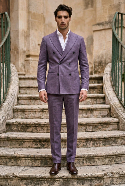 A man wearing a lavender-purple double-breasted suit with a white shirt and brown leather shoes, standing on stone stairs in front of a historic building.
