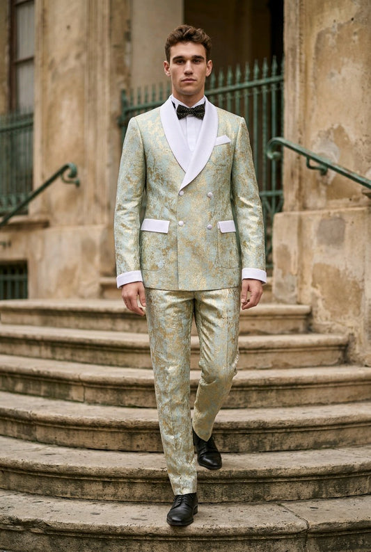 A man wearing a light green and gold patterned double-breasted suit with white shawl lapels, a white shirt, and a black bow tie walks down stone steps in front of a historic building.