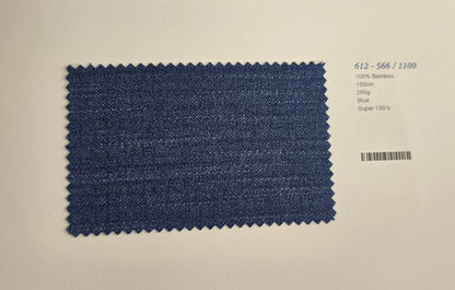 A rectangular blue fabric swatch with zigzag-cut edges displayed on a light beige background, next to printed text showing code 612-566/1100 and material details.