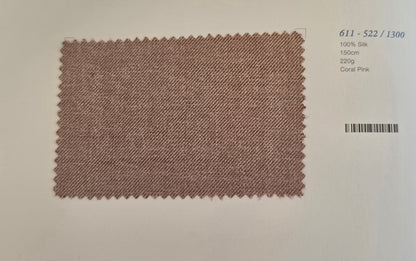 A rectangular coral pink silk fabric swatch with zigzag-cut edges, displayed on a light beige background with printed catalog details in the top right.