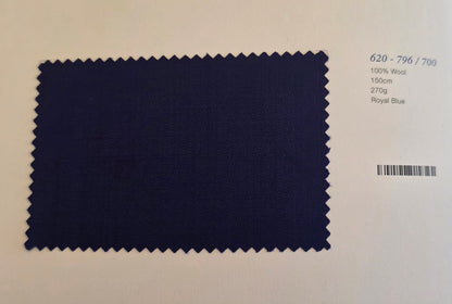 A rectangular fabric swatch of dark royal blue wool with serrated edges, displayed on a light beige background with printed text details on the right.