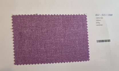 A rectangular lavender-colored fabric swatch with serrated edges, displayed on a white background next to printed text identifying the color and specifications.