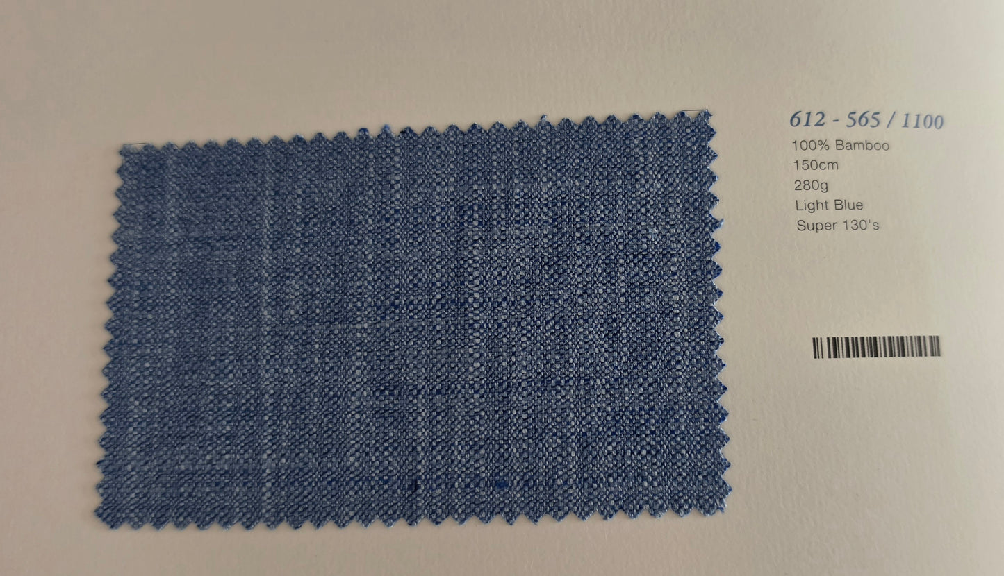 A rectangular light blue bamboo fabric swatch with a zigzag-cut edge, displayed on a white background next to printed product details including a barcode and color code 612-565/1100.