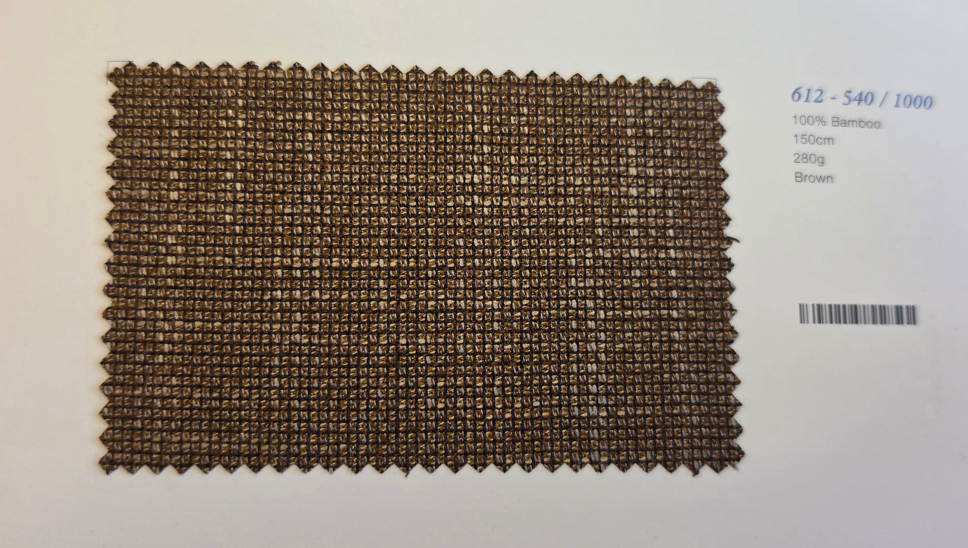 A rectangular woven bamboo fabric swatch in brown, displayed on a white background next to printed text with a barcode.