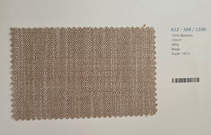 A rectangular woven fabric swatch in a light beige/tan color with a textured basketweave pattern, displayed on a white background next to a barcode and product details text.