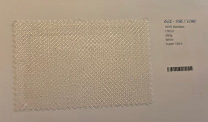 A square fabric swatch of off-white bamboo textured material with zigzag cut edges, displayed on a light background next to printed product details.