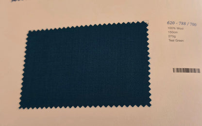 A square fabric swatch of teal green wool with serrated edges, displayed on a light beige paper card with printed text details.