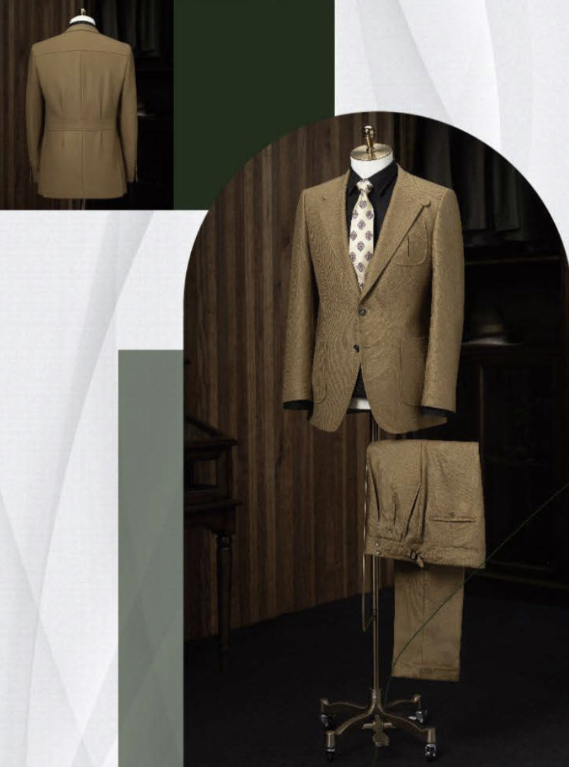 A tan twill casual jacket and trousers displayed on a mannequin, with the jacket featuring a notched lapel, single button front, and waistcoat. The trousers have a belt and button details.