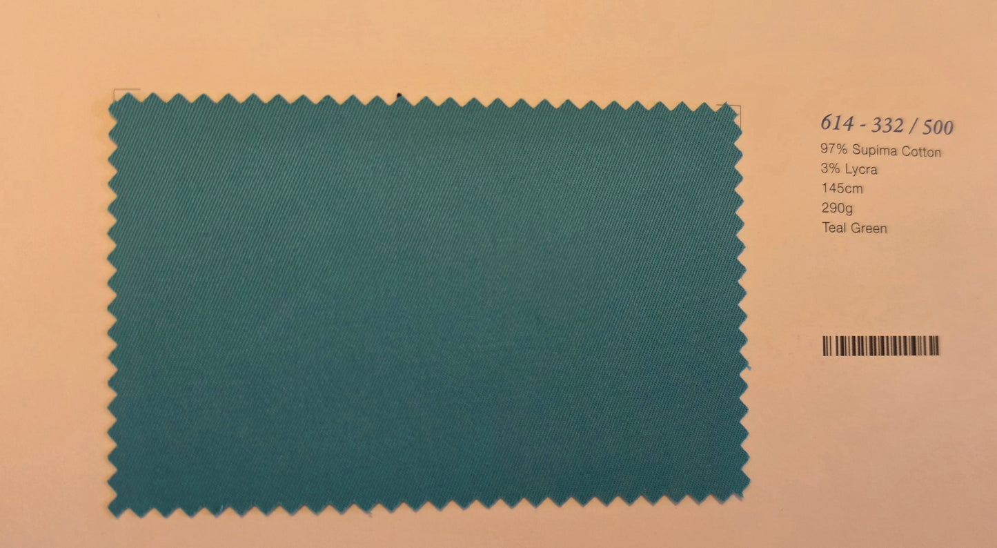 A teal green fabric swatch card with serrated edges, displayed on a peach-colored background with printed text details on the right side.