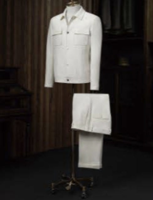 A white wool casual jacket and white wool trousers displayed on a mannequin against a wooden background.