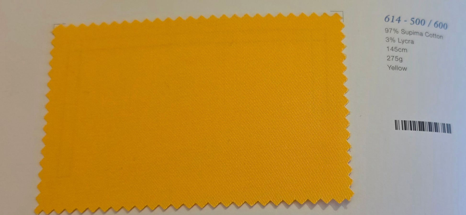 A yellow fabric color swatch with serrated edges on a white background, next to printed text showing color code 614 - 500 / 600 and material details.