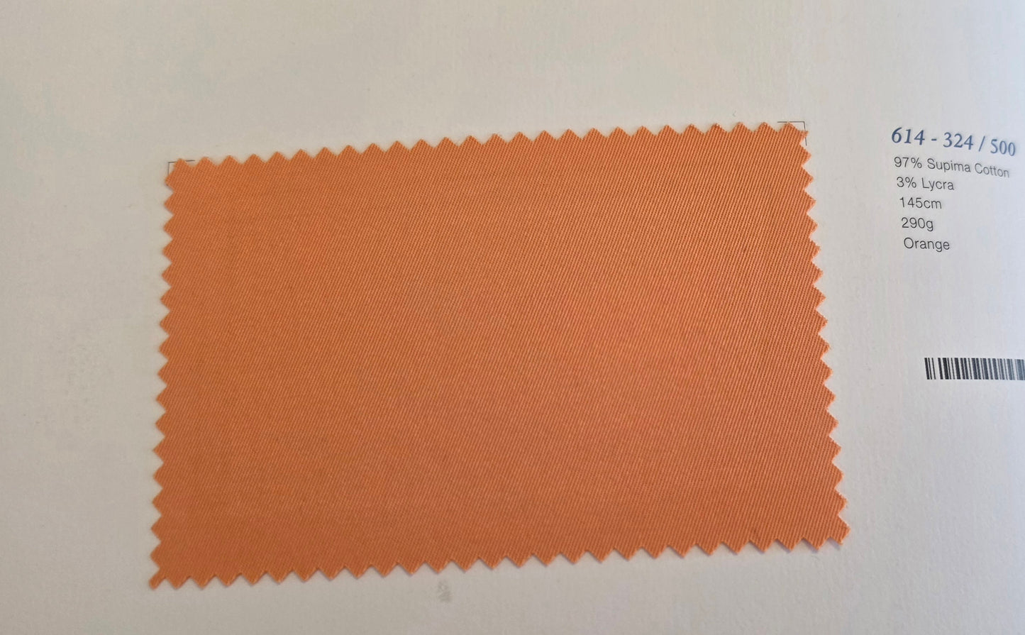 An orange fabric swatch with zigzag-cut edges displayed on a white background next to printed color information.