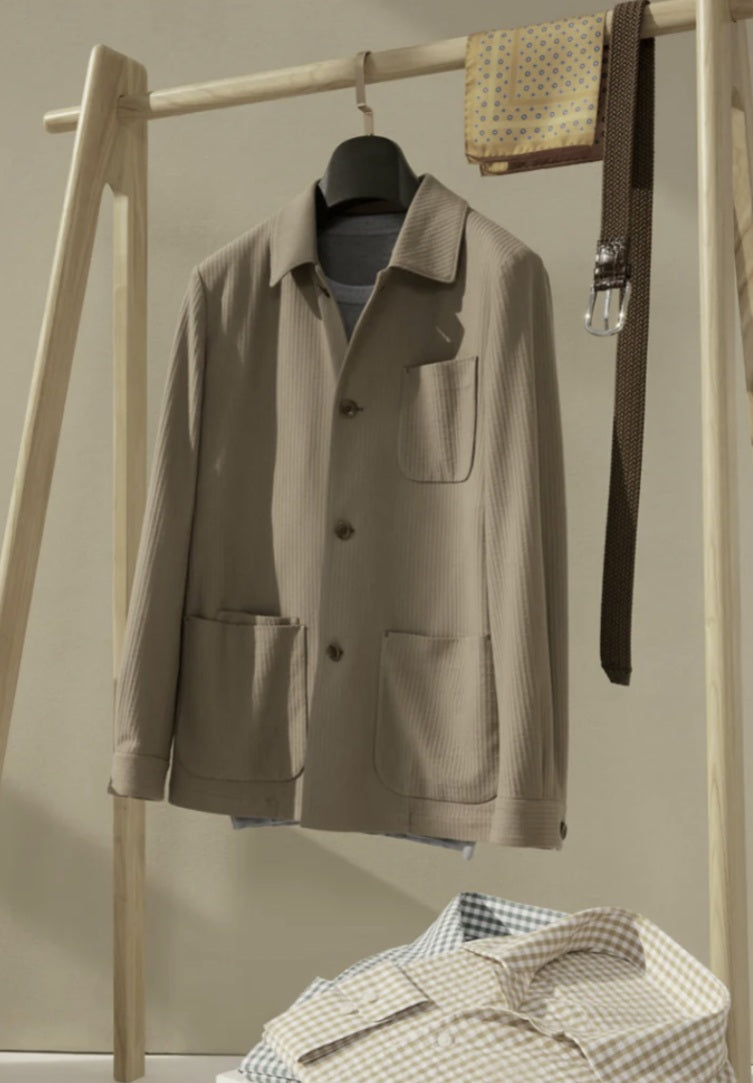 Beige jacket on a wooden rack with a neutral background