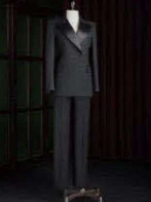 Black suit on a mannequin against a dark background