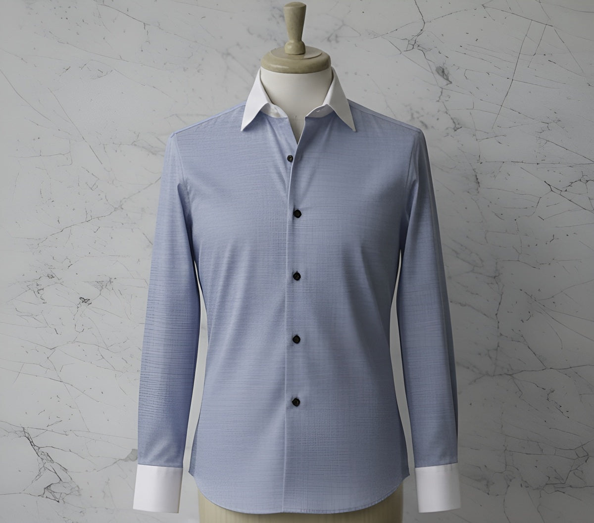 Blue textured stretch shirt on a mannequin against a marble background