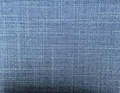 A close-up of a blue woven fabric with a subtle plaid pattern, showing the texture and weave detail.