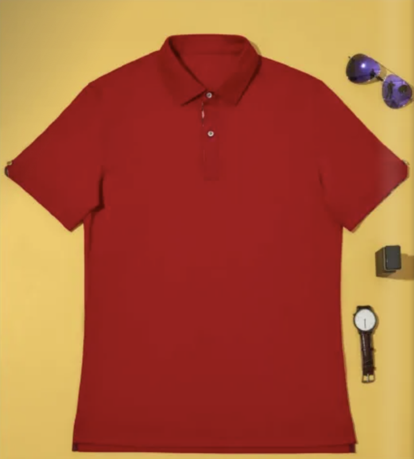 Red polo shirt on a yellow background with sunglasses and a watch.