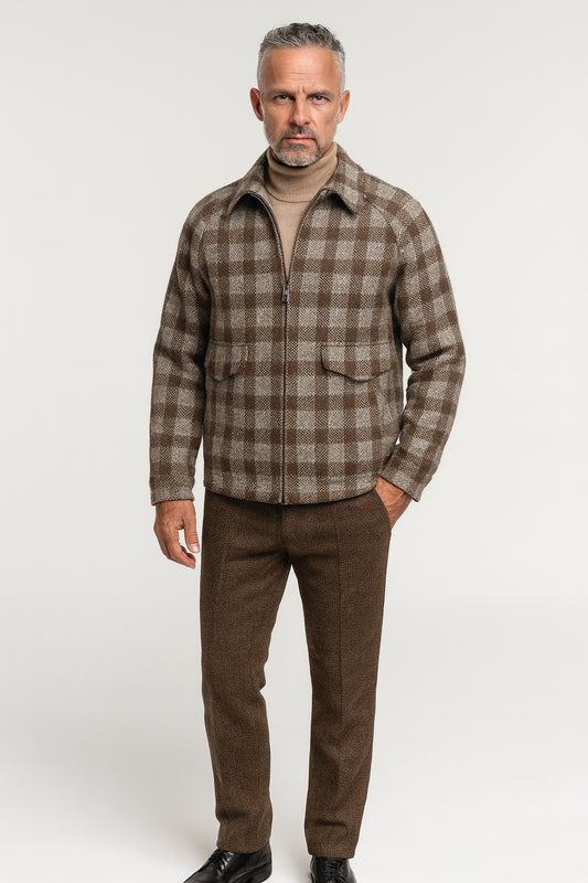 Man wearing a brown plaid shirt and pants on a white background