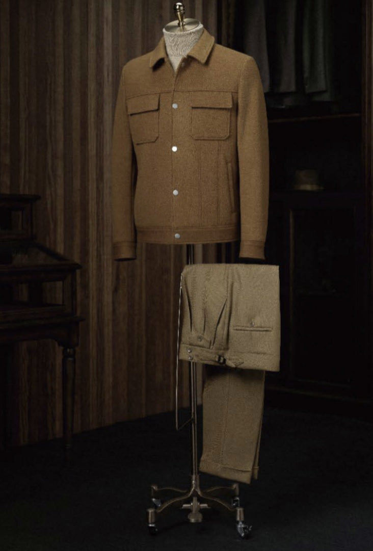 Brown jacket and pants on a mannequin with a dark background