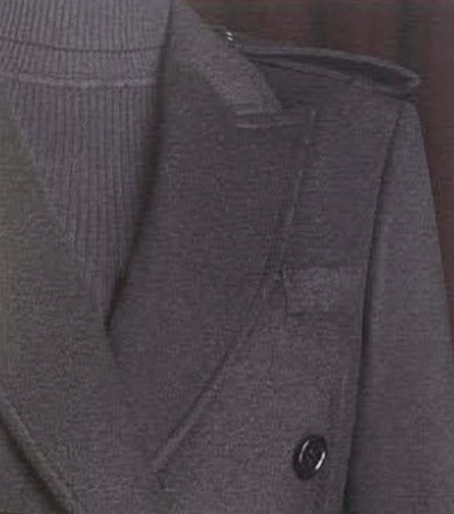 Close-up of a Black coat with a button on a blurred background