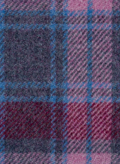 Close-up of a fabric with a plaid pattern in purple, blue, and red.