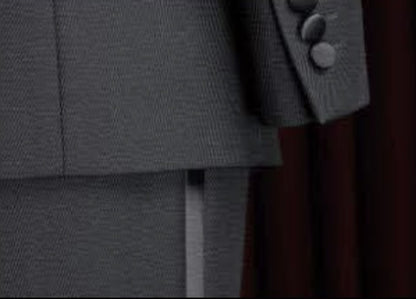 Close-up of a gray textured fabric with buttons on a dark background