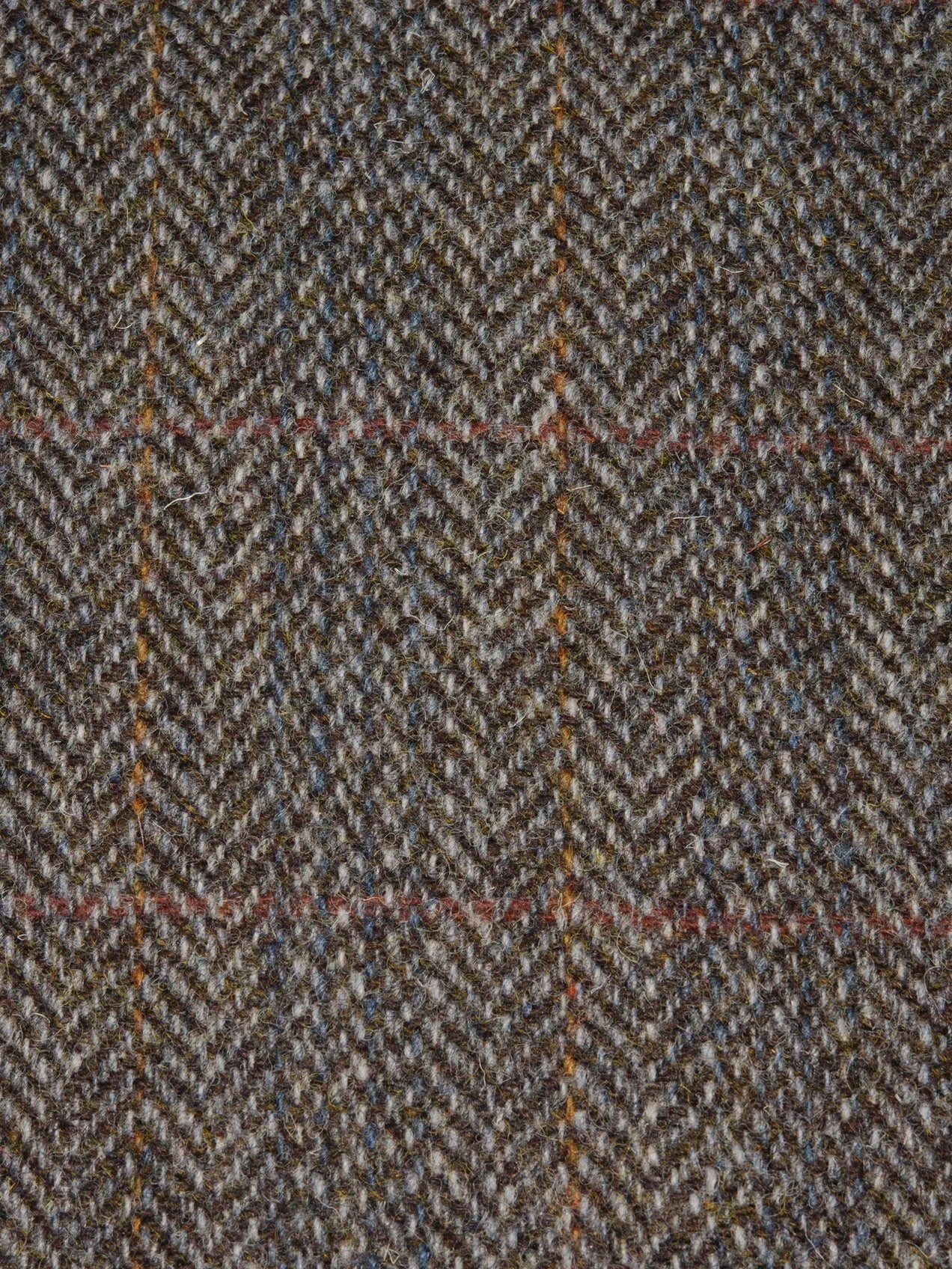 Close-up of a herringbone patterned fabric with brown and beige colors.