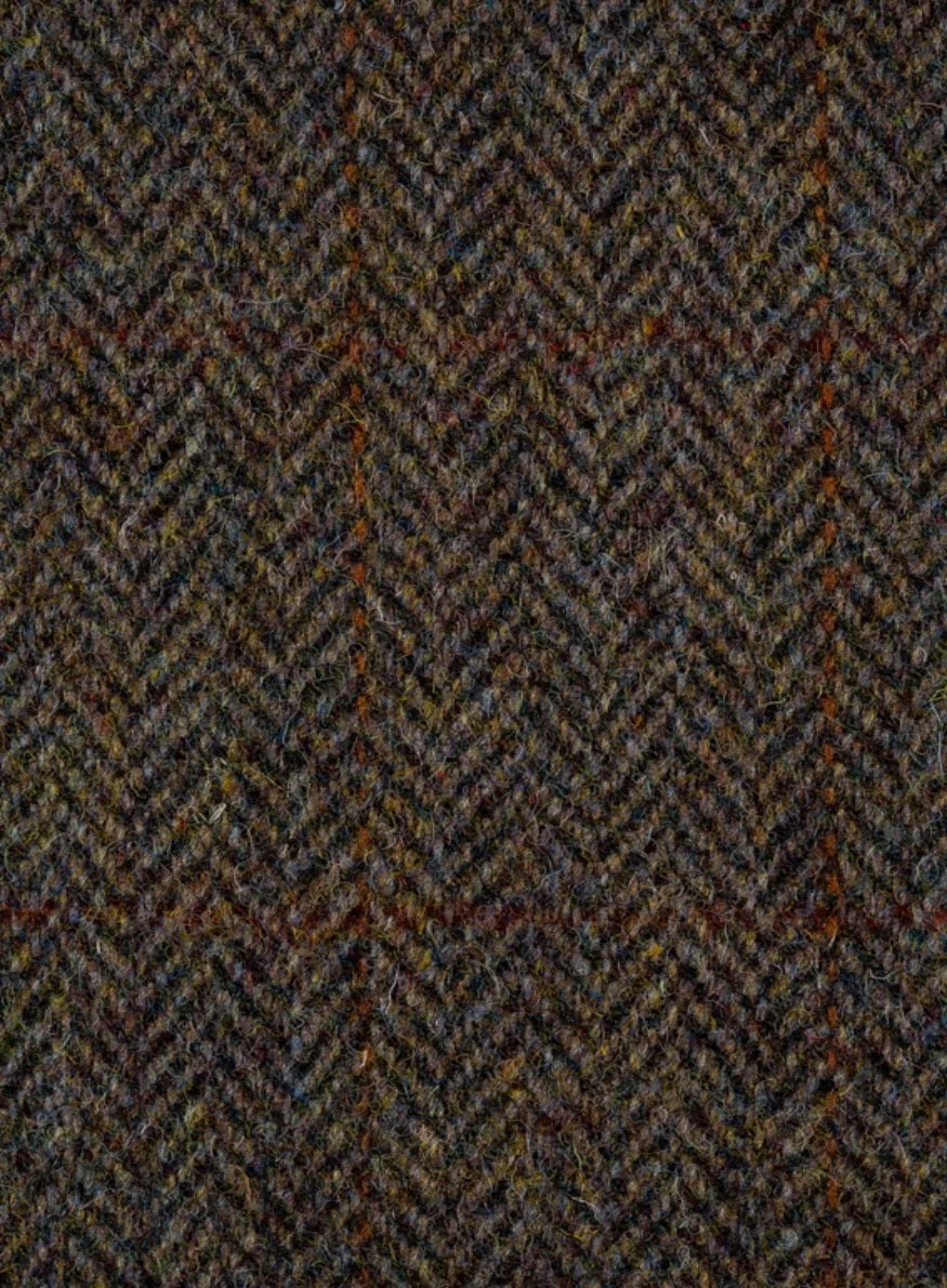 Close-up of a herringbone patterned fabric with earthy tones.