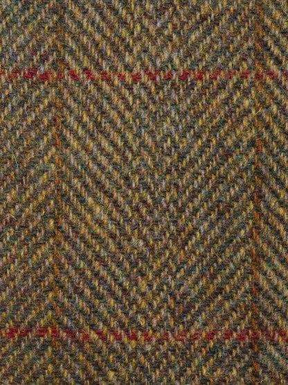 Close-up of a herringbone patterned fabric with earthy tones.