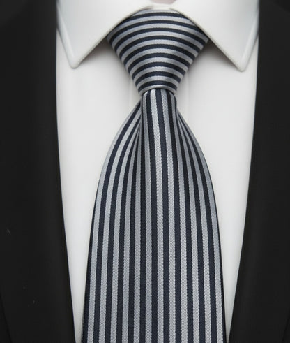 Close-up of a striped tie on a white shirt with black lapels