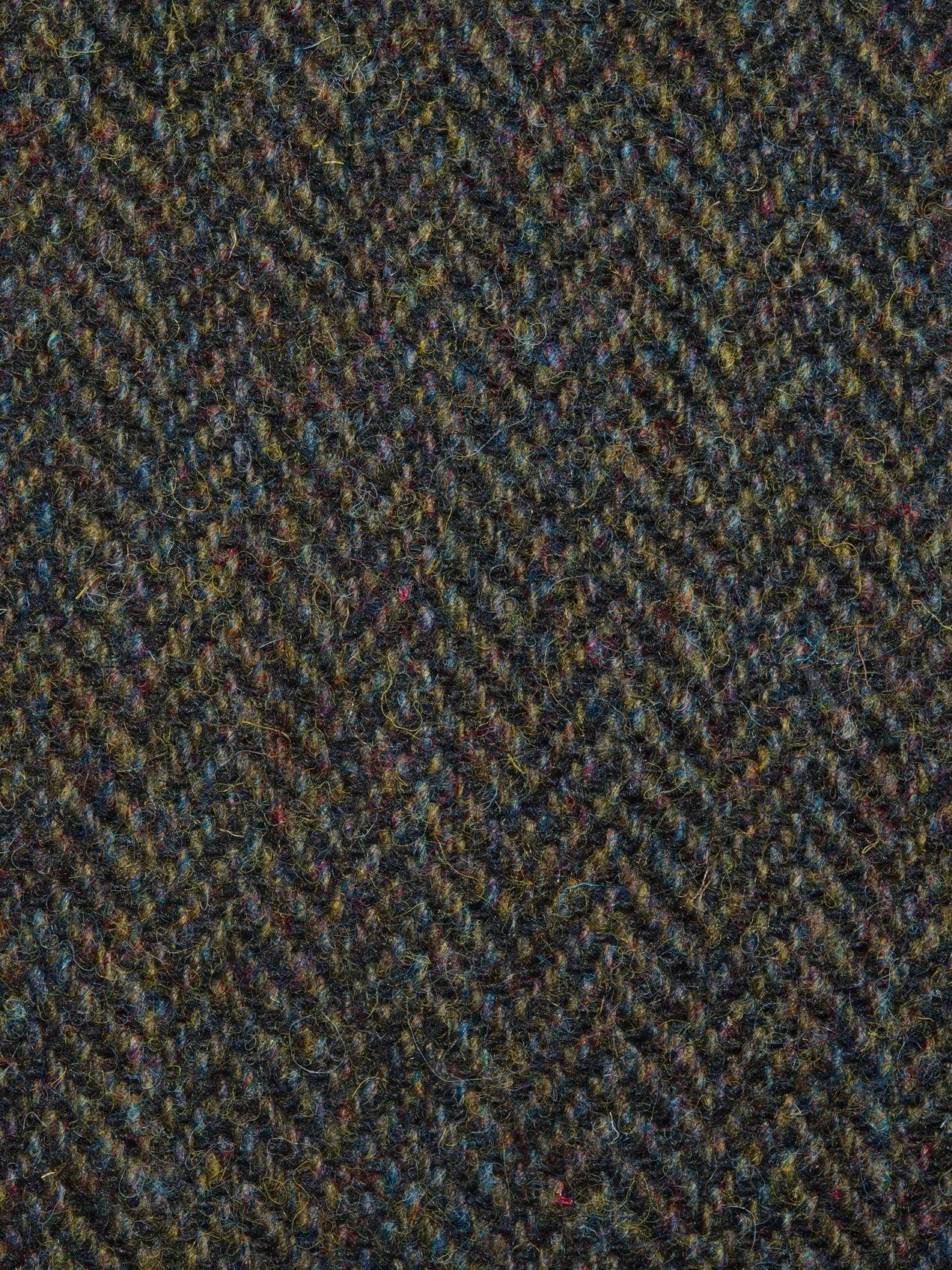 Close-up of a textured fabric with a herringbone pattern in green and brown tones.