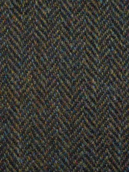 Close-up of a textured fabric with a herringbone pattern in green and brown tones.