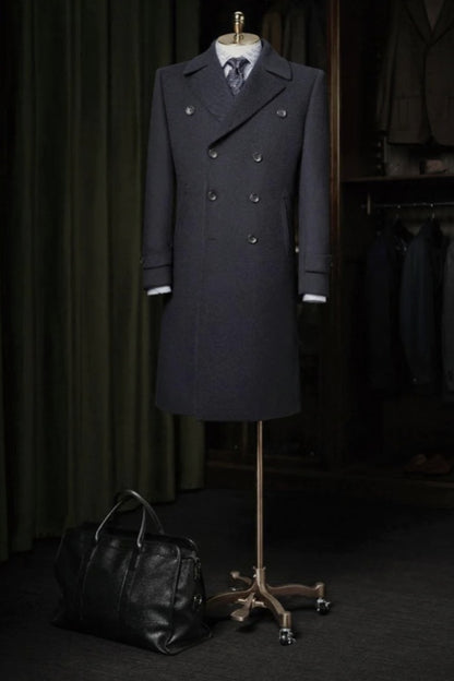 Dark Navy overcoat on a mannequin with a black bag on a dark background