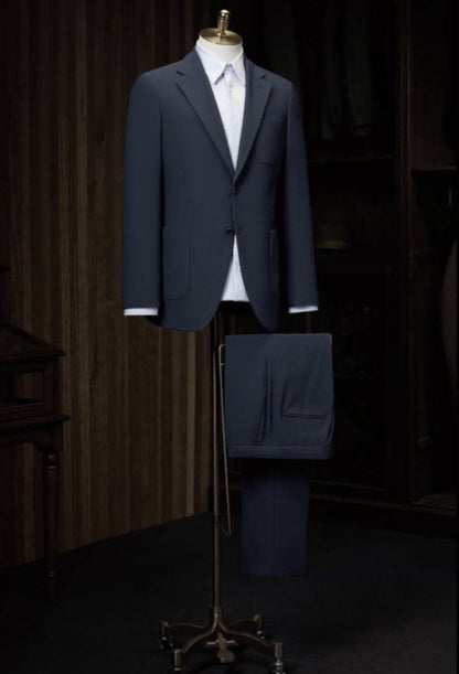 Dark blue suit on a mannequin against a dark background