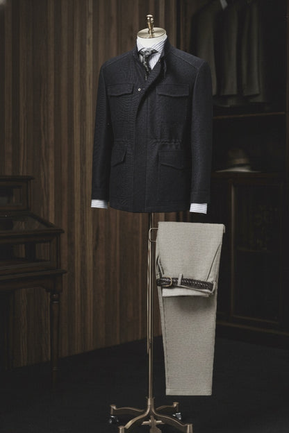 Dark jacket and light pants on a mannequin with a wooden 