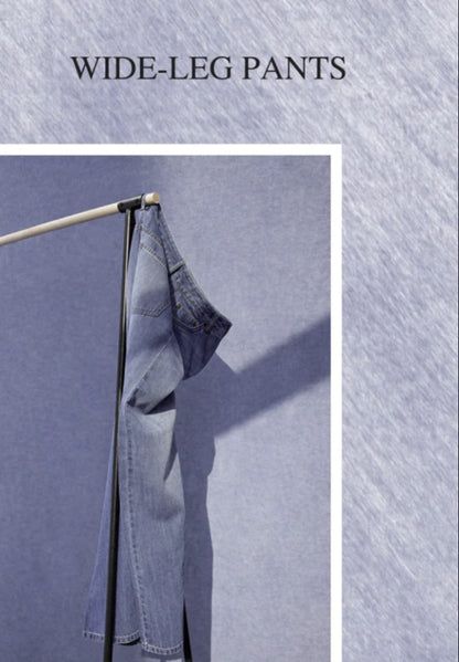 Denim wide-leg pants hanging on a rod against a textured blue background with 'WIDE-LEG PANTS' text.