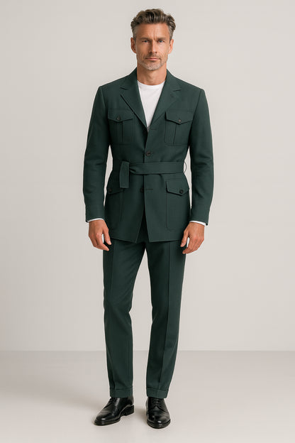 Man wearing a green suit with a white shirt on a plain background