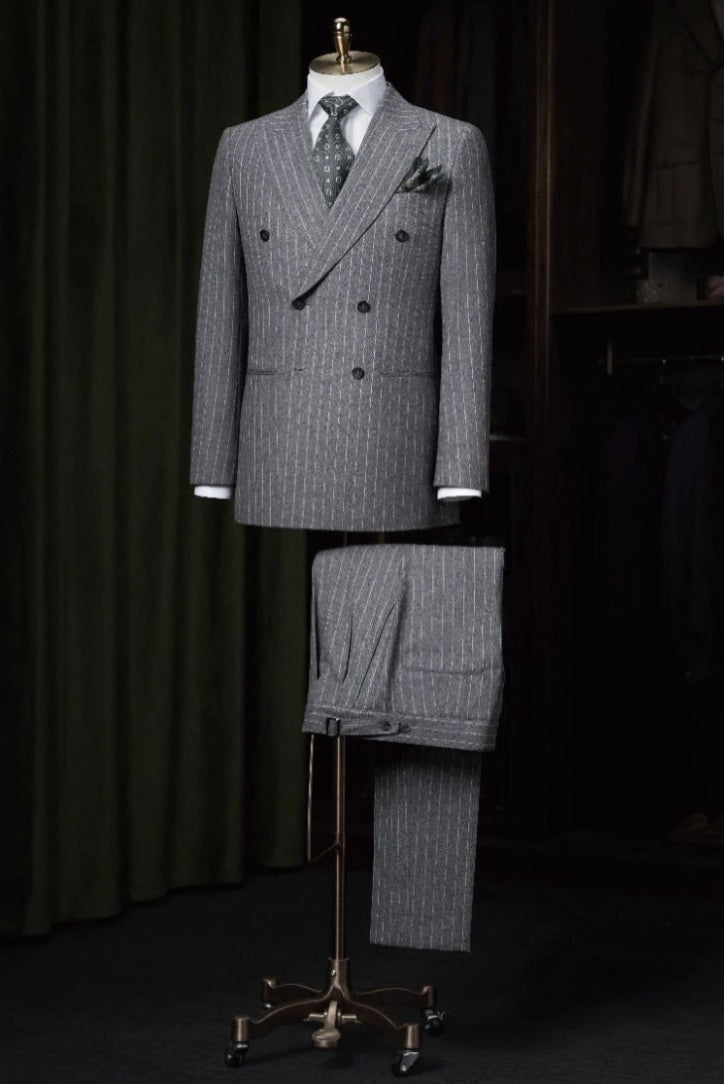 Grey pinstripe suit on a mannequin against a dark background