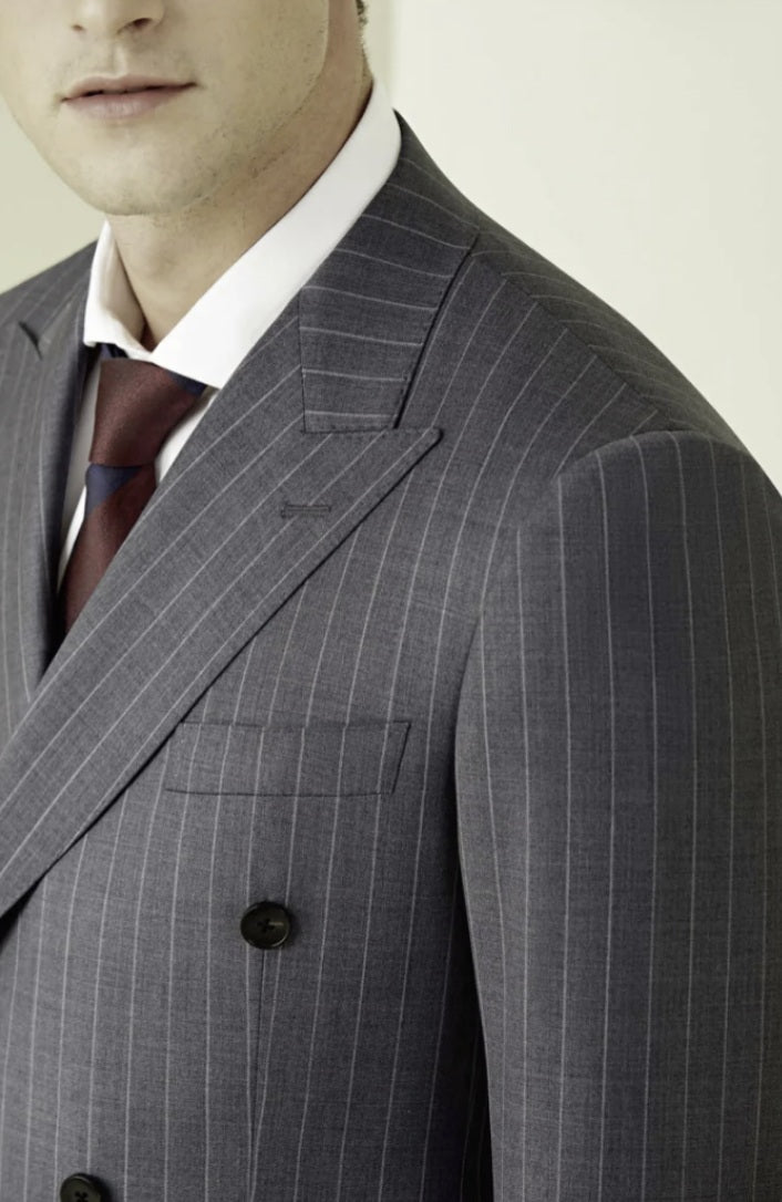 Grey pinstripe suit with a white shirt and brown tie on a plain background