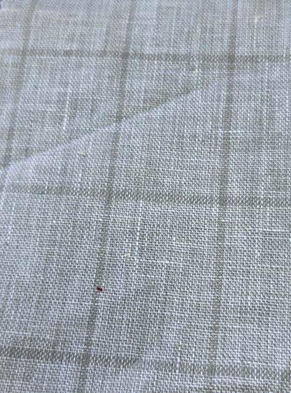 A close-up of a light gray woven fabric with a subtle plaid pattern, showing the texture and weave detail.