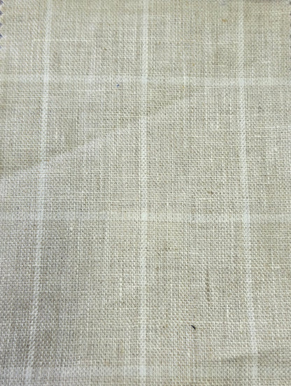 A close-up of a light beige woven fabric with a subtle white windowpane plaid pattern.