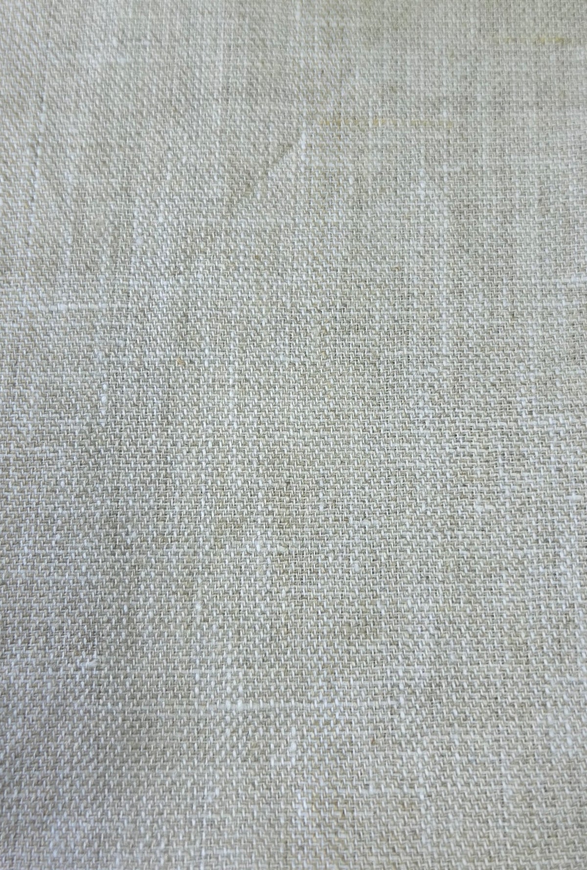 A close-up of a light beige woven fabric texture with a linen-like weave pattern.