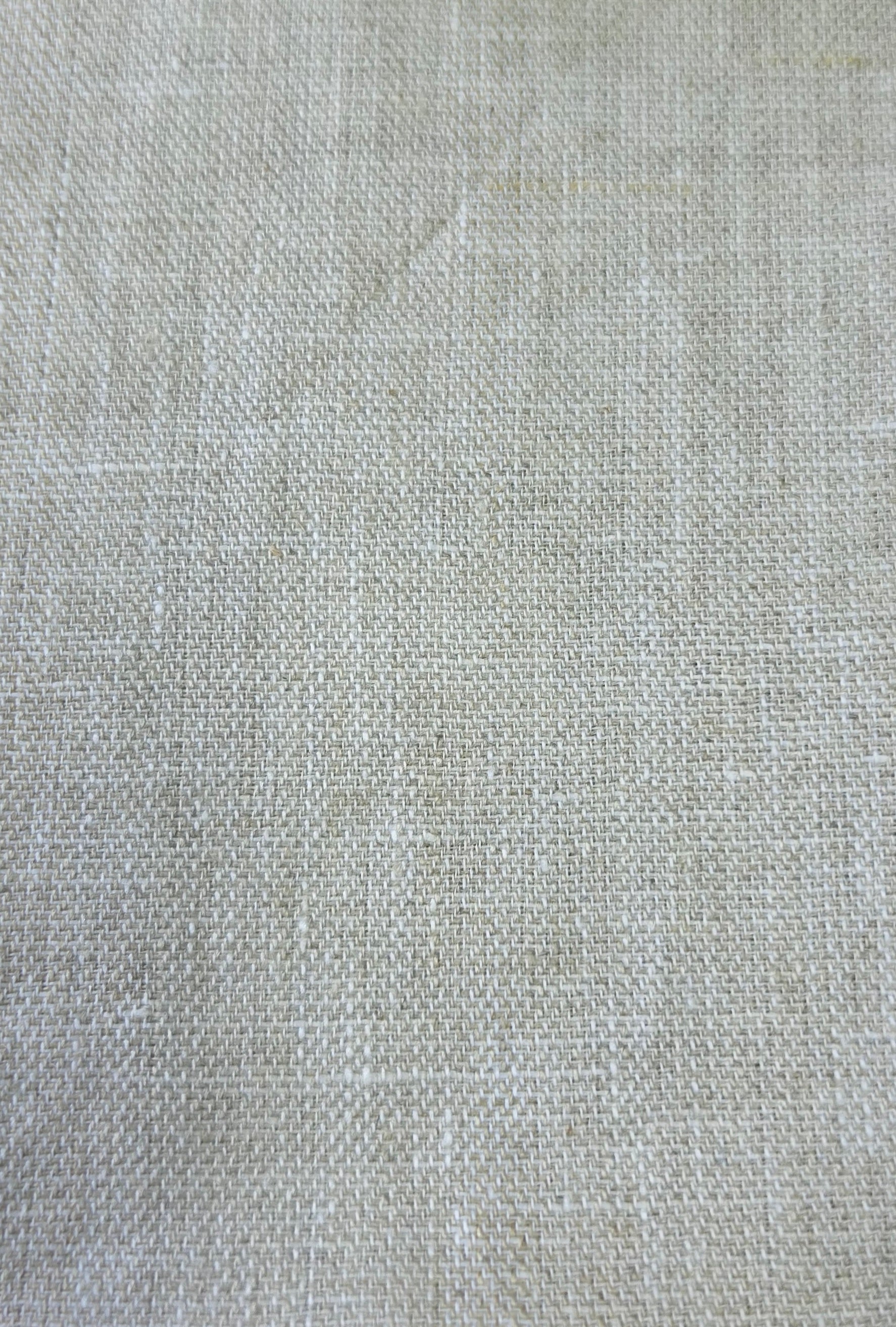 A close-up of a light beige woven fabric texture with a linen-like weave pattern.