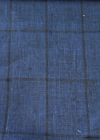 A close-up of blue woven fabric with a subtle dark windowpane plaid pattern.