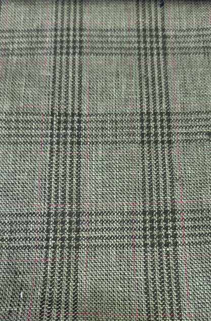 A close-up of woven fabric with a small-scale plaid pattern in olive green black, overlaid with faint pink measurement grid lines.