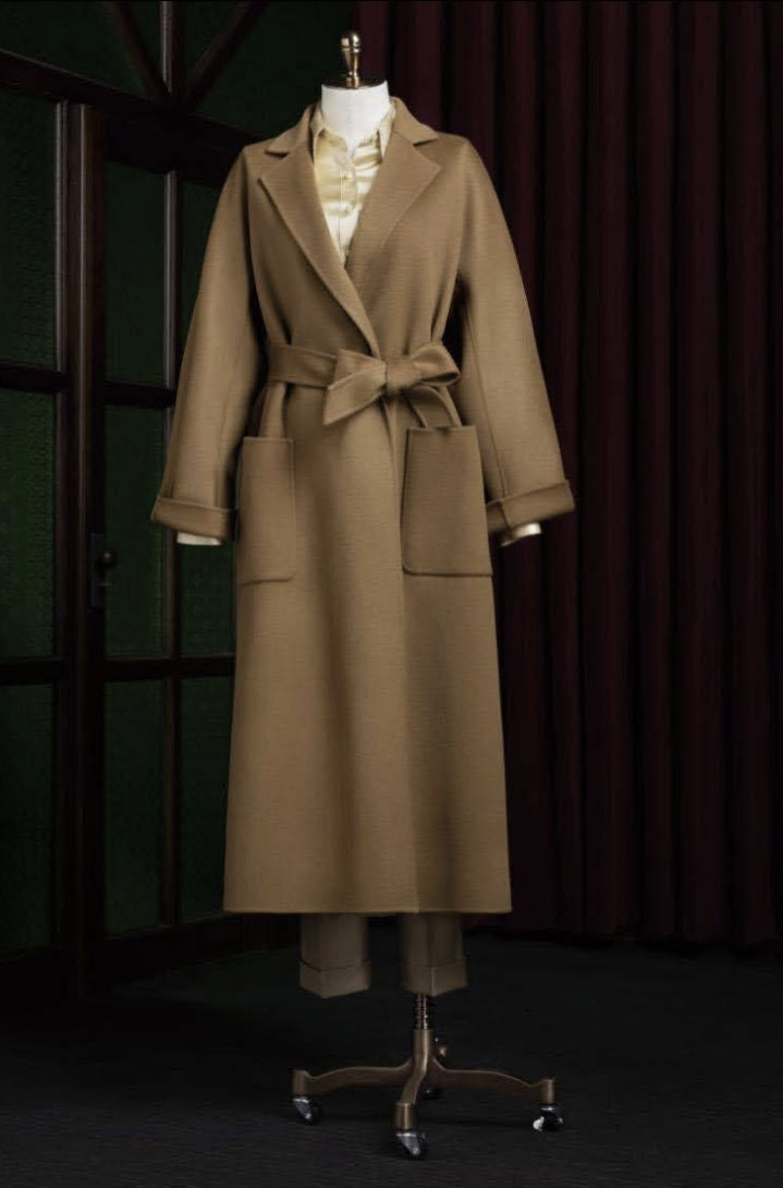 Ladies Beige trench coat on a mannequin against a dark background
