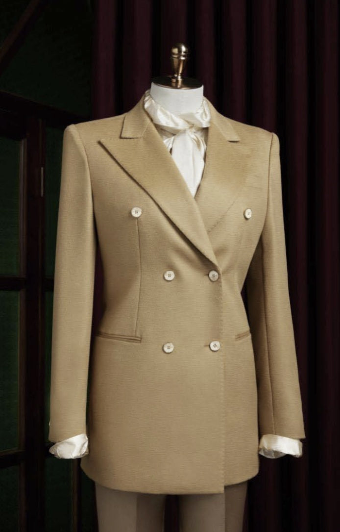 Ladies Beige double-breasted suit on a mannequin against a dark background