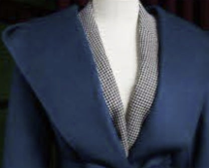 Ladies Blue coat with collar on a mannequin against a dark background