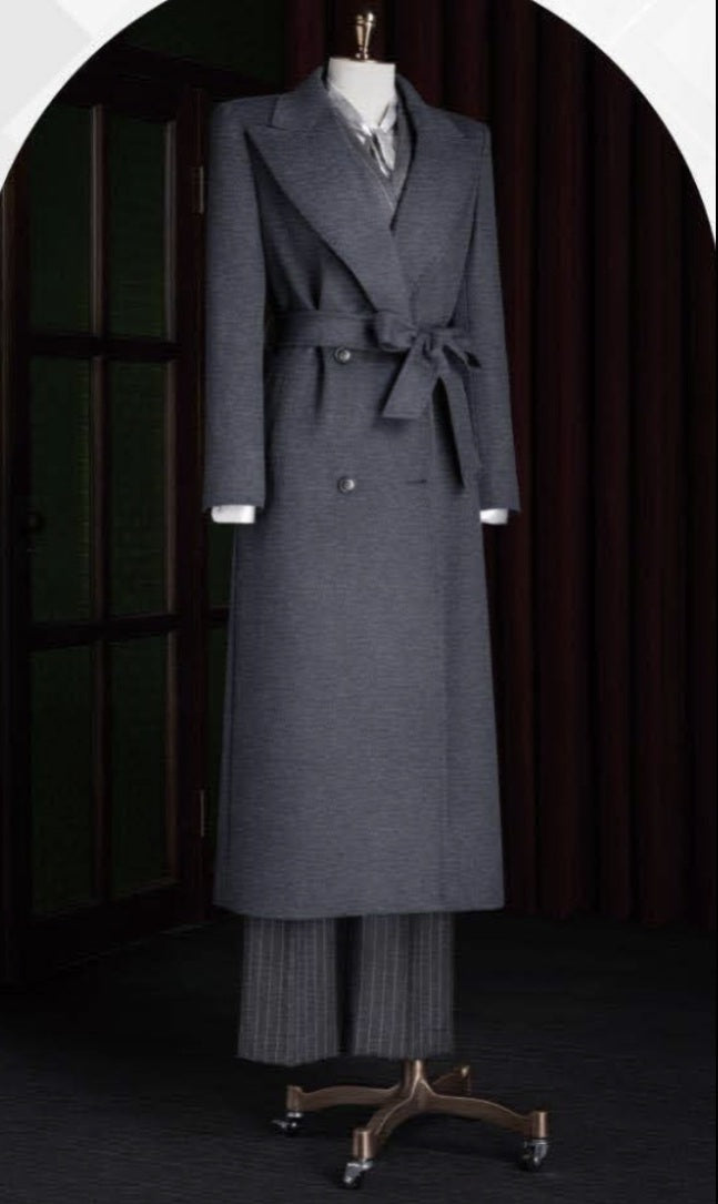 Ladies Grey coat and pants on a mannequin against a dark background